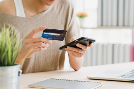 Asian woman using smartphone buying online shopping